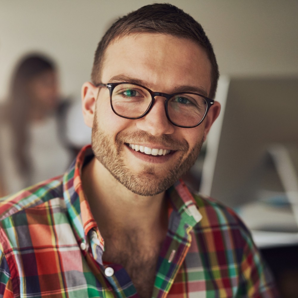 Cheerful entrepreneur wearing glasses in the office